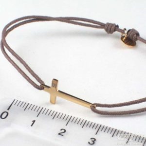 Bracelet in the shape of a small cross in Vermeil from L'AVARE jewelry mounted on cotton thread taupe